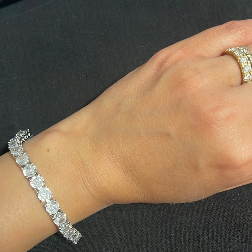 White gold plated 7” women’s tennis bracelet with large cubic zirconia stones.